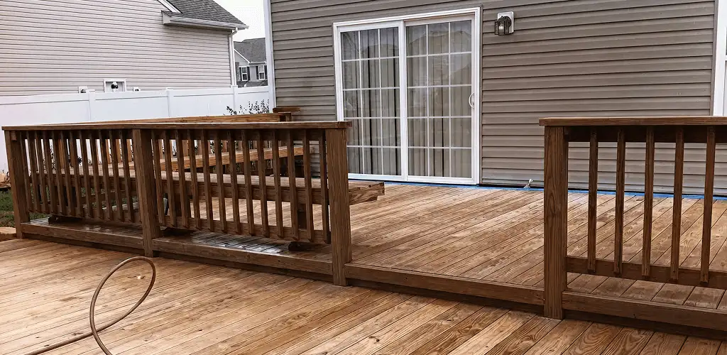 Deck sealing service protecting a backyard wood deck and railings in Hialeah, FL
