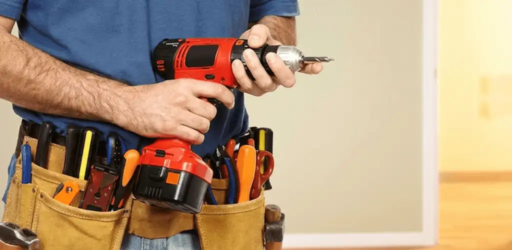 Handyman holding a power drill for home repairs and installations in Hialeah, FL