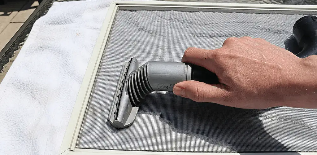 Window screen repair cleaning and fixing a damaged screen mesh in Hialeah, FL